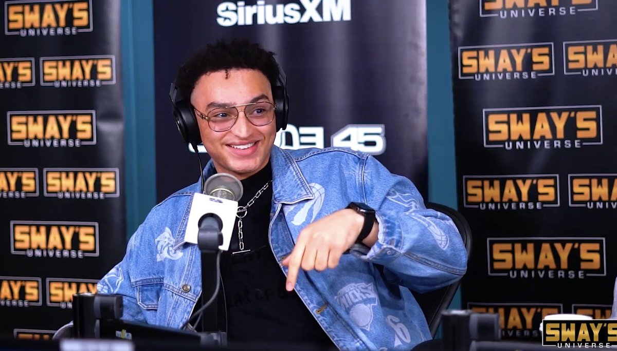 Nic wearing headphones at a SiriusXM microphone